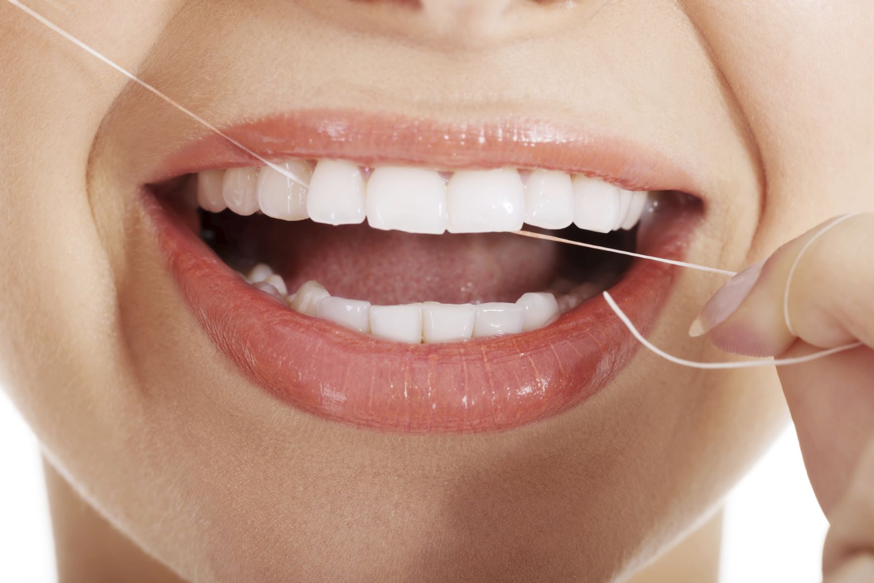 A woman flossing to show the importance of flossing for oral care